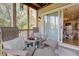 Comfortable screened porch with seating area and sliding glass door to inside of the house at 1551 Ben Sawyer Blvd # 4D, Mount Pleasant, SC 29464