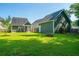 Expansive backyard with lush green grass, fire pit, screened porch, and ample space for outdoor activities at 1607 Roustabout Way, Charleston, SC 29414