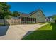 The backyard showcases a spacious screened-in porch, green siding, and a well-maintained lawn at 1607 Roustabout Way, Charleston, SC 29414