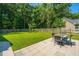 Outdoor patio with a stone tile surface, featuring a dining set and a well-manicured lawn at 1607 Roustabout Way, Charleston, SC 29414