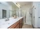 Bathroom boasts a double sink vanity, granite countertops, and a glass-enclosed shower at 1607 Roustabout Way, Charleston, SC 29414