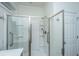 Bathroom featuring modern, glass-enclosed shower with accessibility grab bars and white tile at 1607 Roustabout Way, Charleston, SC 29414