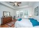 Bright bedroom featuring a ceiling fan, tray ceiling, and natural light from the windows at 1607 Roustabout Way, Charleston, SC 29414