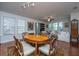 Inviting dining area with wood table, hardwood floors, rug, and an adjacent living area with natural light at 1607 Roustabout Way, Charleston, SC 29414