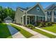 Charming home with a well-manicured lawn, colorful flowerbeds, and a convenient detached garage at 1607 Roustabout Way, Charleston, SC 29414