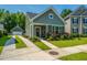 Charming home with a well-manicured lawn, colorful flowerbeds, and a convenient detached garage at 1607 Roustabout Way, Charleston, SC 29414