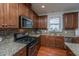 Gourmet kitchen boasting stainless steel appliances, granite countertops, and custom cabinetry at 1607 Roustabout Way, Charleston, SC 29414