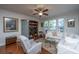 Cozy living room with a ceiling fan, plush white sofa, comfortable chairs, and natural light at 1607 Roustabout Way, Charleston, SC 29414