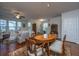 Open concept living room and dining area with hardwood floors and ample natural light from large windows at 1607 Roustabout Way, Charleston, SC 29414