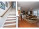 Open-concept living area featuring hardwood floors, stairs, a dining area, and a modern kitchen at 1607 Roustabout Way, Charleston, SC 29414