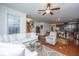 Open-concept living area with a white sofa, ceiling fan, hardwood floors, and a view into the kitchen at 1607 Roustabout Way, Charleston, SC 29414