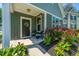 Inviting front porch with chairs, colorful flowers, and a welcoming 'Welcome' sign at 1607 Roustabout Way, Charleston, SC 29414