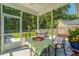 Relaxing screened porch with outdoor seating and views of the lush backyard and surrounding trees at 1607 Roustabout Way, Charleston, SC 29414