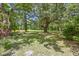 Lush backyard with mature trees providing ample shade and a serene atmosphere at 1736 Central Ave, Summerville, SC 29483