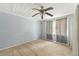 Bedroom with wood floors, light walls, ceiling fan, and bright windows at 1736 Central Ave, Summerville, SC 29483