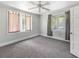 Cozy bedroom with a ceiling fan, neutral carpeting, natural lighting from windows, and neutral walls at 1736 Central Ave, Summerville, SC 29483