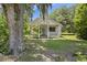 Charming single story home with a cozy front porch, framed by mature trees and a lush green lawn at 1736 Central Ave, Summerville, SC 29483