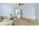 Laundry room with blue walls, a ceiling fan, unfinished floors, and a washing machine at 1736 Central Ave, Summerville, SC 29483