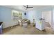 Laundry room with blue walls, a ceiling fan, unfinished floors, and a washing machine at 1736 Central Ave, Summerville, SC 29483