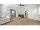 Living room featuring unfinished hardwood floors, a ceiling fan, and doorways leading to other rooms at 1736 Central Ave, Summerville, SC 29483