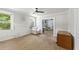 Living room featuring unfinished hardwood floors, a decorative fireplace, a ceiling fan, and neutral-colored walls at 1736 Central Ave, Summerville, SC 29483