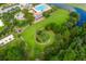 Wide aerial shot of a community featuring a pool, playground and well-manicured green spaces with a winding walking path at 1844 Hubbell Dr, Mount Pleasant, SC 29466