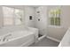 Primary bathroom featuring soaker tub and marble tiled shower at 1844 Hubbell Dr, Mount Pleasant, SC 29466