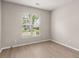Cozy bedroom with neutral walls, vinyl floors, and a window view of the neighborhood at 1844 Hubbell Dr, Mount Pleasant, SC 29466