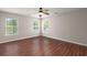 Bedroom with ceiling fan, wood-look floors, and two large windows at 1844 Hubbell Dr, Mount Pleasant, SC 29466