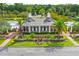 View of the community clubhouse with lush landscaping featuring plants, palm trees and manicured lawns at 1844 Hubbell Dr, Mount Pleasant, SC 29466