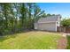 View of the garage exterior shows a small yard with fresh landscaping near a fenced backyard at 1844 Hubbell Dr, Mount Pleasant, SC 29466