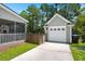 A detached one-car garage with a white door sits next to a fenced yard and a screened-in porch at 1844 Hubbell Dr, Mount Pleasant, SC 29466