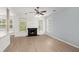 Bright living room featuring a fireplace, hardwood floors, and large windows for natural light at 1844 Hubbell Dr, Mount Pleasant, SC 29466