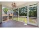 An outdoor, screened porch featuring a chandelier with a view of a serene, wooded backyard at 1844 Hubbell Dr, Mount Pleasant, SC 29466