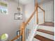 Bright staircase featuring wooden railing and modern light fixture at 1844 Hubbell Dr, Mount Pleasant, SC 29466