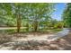 Scenic view of the community walking path along the pond with fountain and trees at 1844 Hubbell Dr, Mount Pleasant, SC 29466