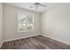 Bright bedroom features wood-look floors, ceiling fan, and a large window with natural light at 1915 Chatelain Way, Mount Pleasant, SC 29464