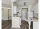 Open kitchen with sleek white appliances, counter seating, and wooden floors at 1915 Chatelain Way, Mount Pleasant, SC 29464