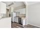 Compact kitchen with white cabinets, stainless steel dishwasher, and wooden floors at 1915 Chatelain Way, Mount Pleasant, SC 29464