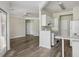 Bright living room features wooden floors, a ceiling fan, and access to the kitchen and exterior at 1915 Chatelain Way, Mount Pleasant, SC 29464