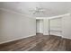 Spacious living room features wood-look floors, ceiling fan, and built-in shelving at 1915 Chatelain Way, Mount Pleasant, SC 29464