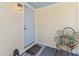 Charming front porch offers a place to sit outside, with a stylish rattan chair and 'hello' welcome mat at 1915 Quitman St, North Charleston, SC 29405