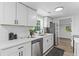 Bright kitchen with white cabinets, stainless appliances, black hardware and patterned rug at 1915 Quitman St, North Charleston, SC 29405