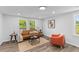 Inviting living room features hardwood floors, two large windows, and comfortable seating at 1915 Quitman St, North Charleston, SC 29405