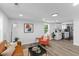 Bright living room with fresh paint, modern lighting, and open access to kitchen featuring stainless appliances at 1915 Quitman St, North Charleston, SC 29405