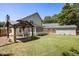 Spacious backyard featuring lush grass, storage shed, pergola, and screened-in porch at 2009 Arundel Pl, Mount Pleasant, SC 29464