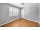 Bright bedroom featuring plantation shutters, ceiling fan, and hardwood flooring at 2009 Arundel Pl, Mount Pleasant, SC 29464
