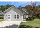 Charming single-story home with light siding, a well-manicured lawn, and a vibrant crape myrtle tree at 2009 Arundel Pl, Mount Pleasant, SC 29464