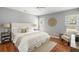 Serene main bedroom with a plush bed, ceiling fan, hardwood floors, and an inviting sitting area at 2009 Arundel Pl, Mount Pleasant, SC 29464