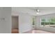 Bright room with a ceiling fan, wood-look floors, window, and a door to the balcony at 2011 N Highway 17 # 1400P, Mount Pleasant, SC 29466